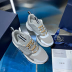 Unisex sneakers on box, light gray mesh, gold laces, and contrast heel tabs