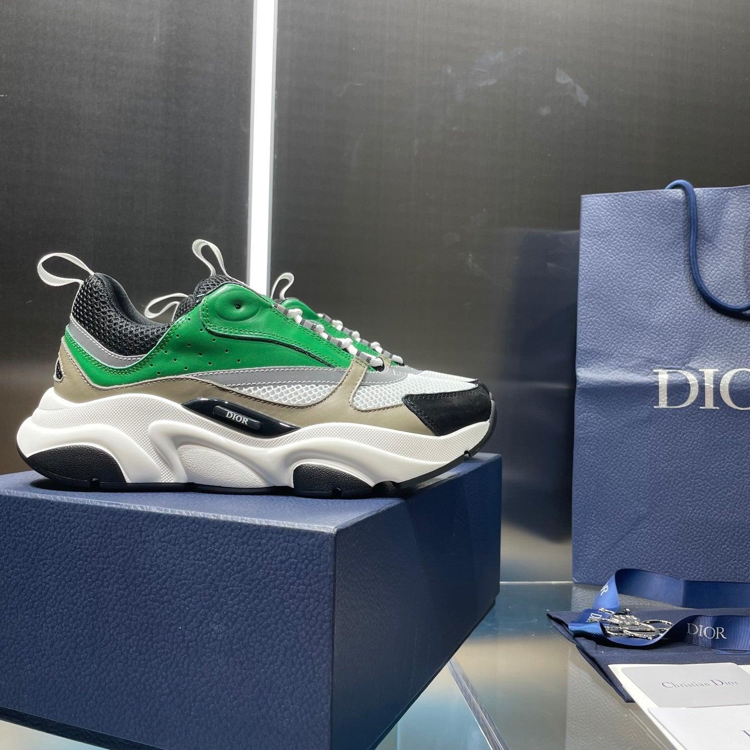 Green and white lace-up sneakers with black trim, chunky sole, and mesh panels