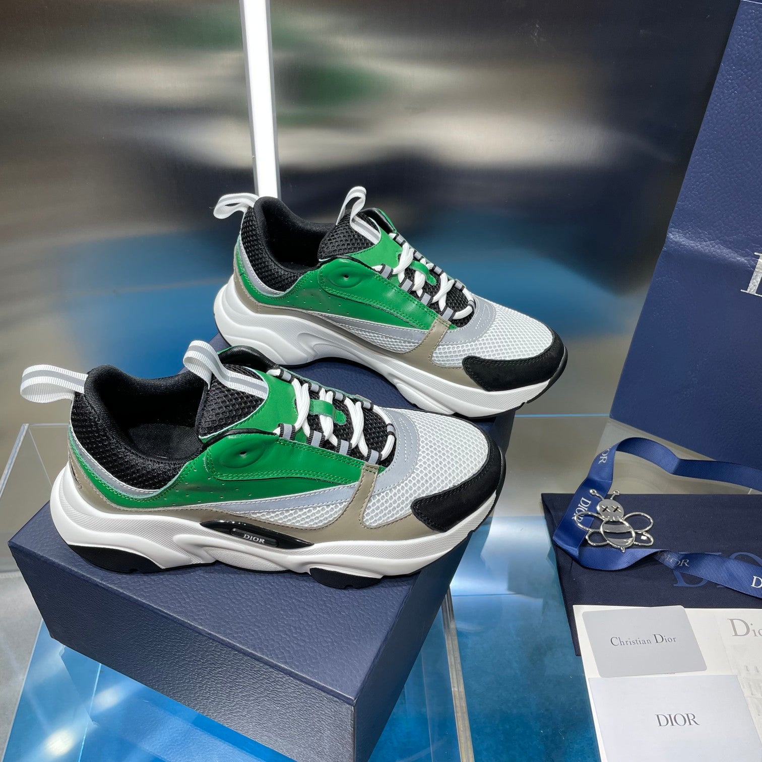 White, green, and black lace-up sneakers with chunky sole and sporty tread