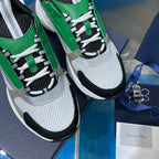 Close-up of green and white lace-up sneakers with black laces and textured uppers