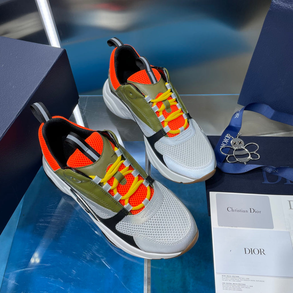 Dior unisex sneakers side view: white sole, olive green body, orange mesh, colorful laces