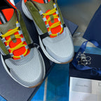Dior unisex sneakers close-up: olive upper with orange mesh, multicolor lace-up detail