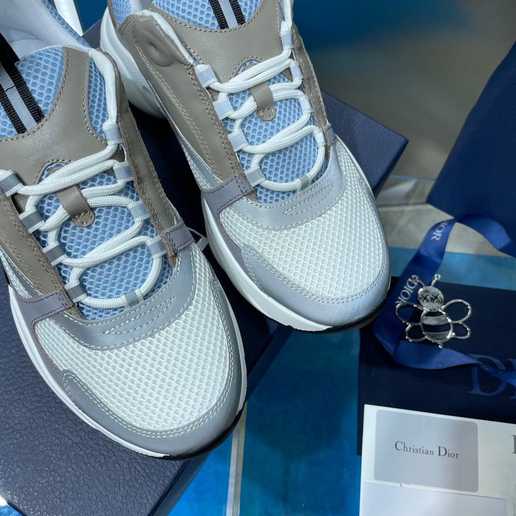 Unisex sneakers close-up showing light blue mesh laces and beige side panels