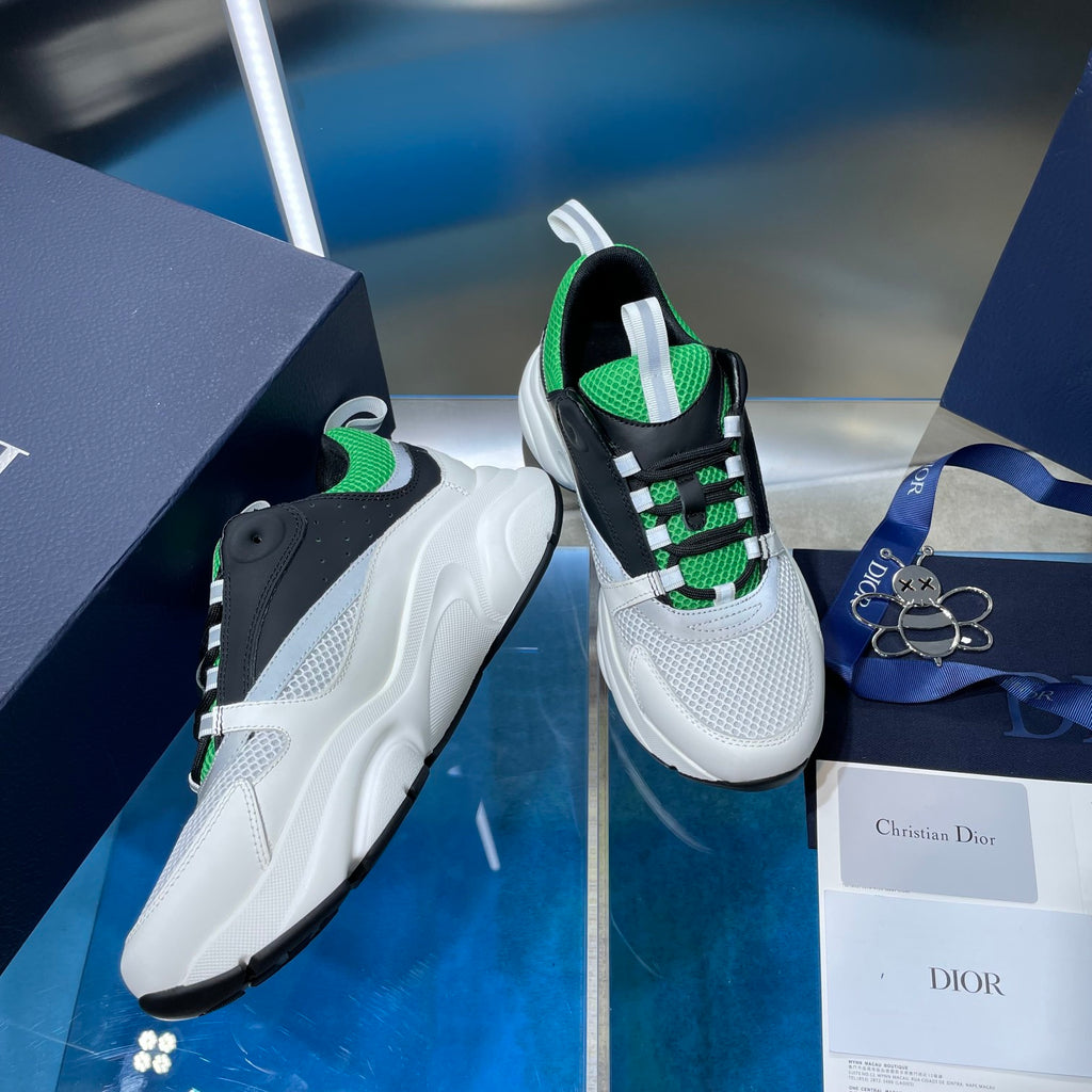 Dior unisex sneakers, angled view with white and black uppers and green trim