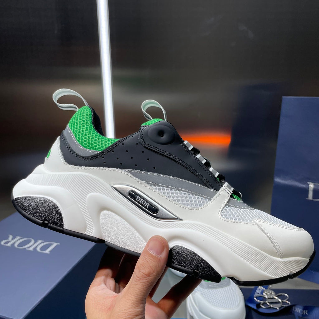Dior unisex sneaker, side profile in white with black overlays and green collar