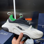 Dior unisex sneaker, side profile in white with black overlays and green collar