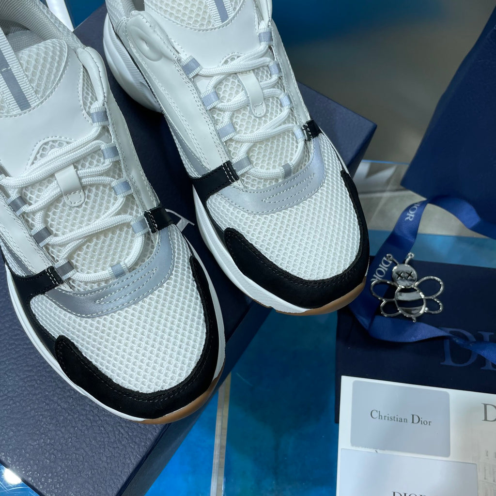 Unisex Dior sneakers close-up, white laces and mesh knit with black side accent