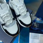 Unisex Dior sneakers close-up, white laces and mesh knit with black side accent