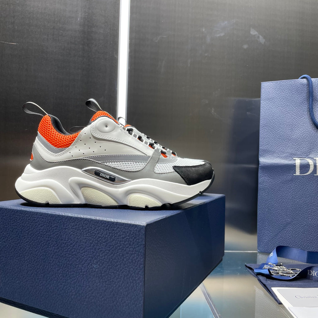 Dior unisex lace-up sneakers, white mesh upper with orange lining and black side accents.