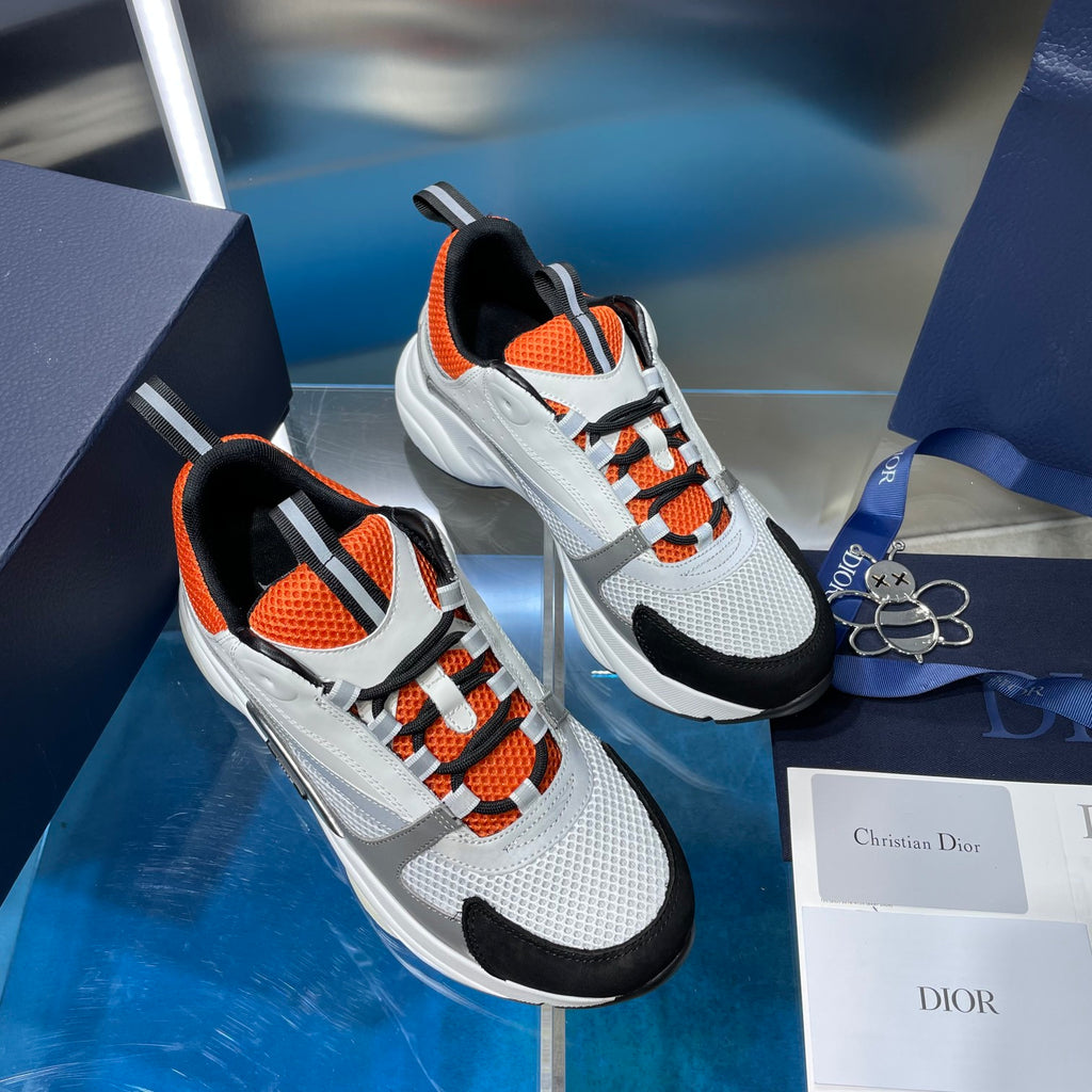 Dior unisex lace-up sneakers, white and gray knit with orange laces and black toe caps.