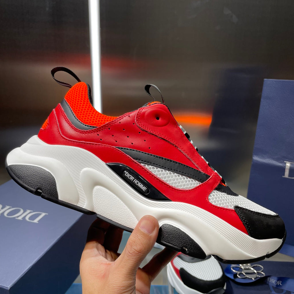Dior chunky sneakers with red and orange panels, black toe, and thick white sole