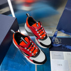 Dior chunky sneakers with red, orange, black and white uppers on display boxes