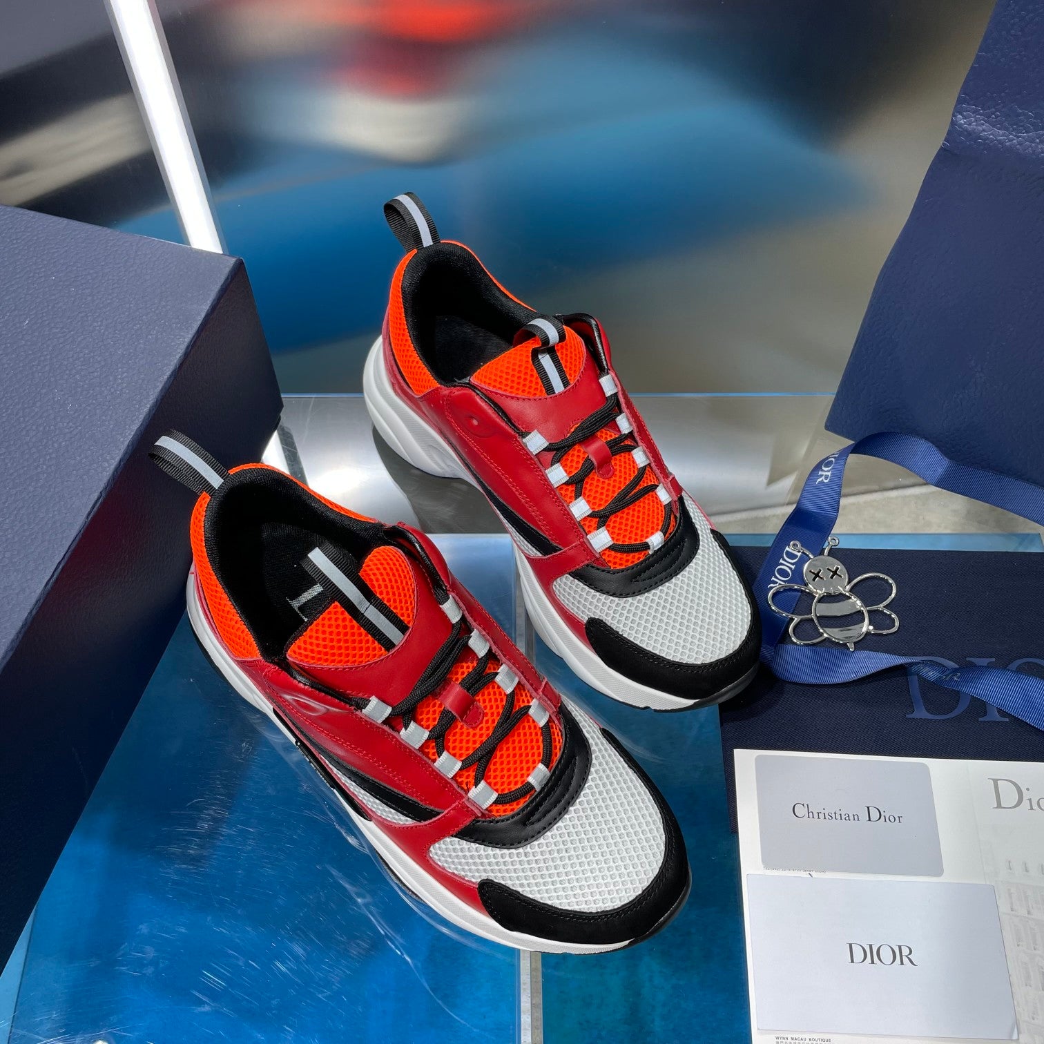 Dior chunky sneakers with red, orange, black and white uppers on display boxes
