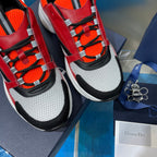 Dior chunky sneakers close-up: lace-up red, orange, black and white mesh uppers