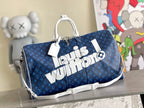 Men's blue monogram duffel bag with top handles and white strap accent