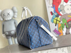 Blue monogram duffel bag with zipper, shoulder strap, and silver hardware
