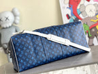 Blue monogram duffel bag with white strap and silver-tone hardware detail.