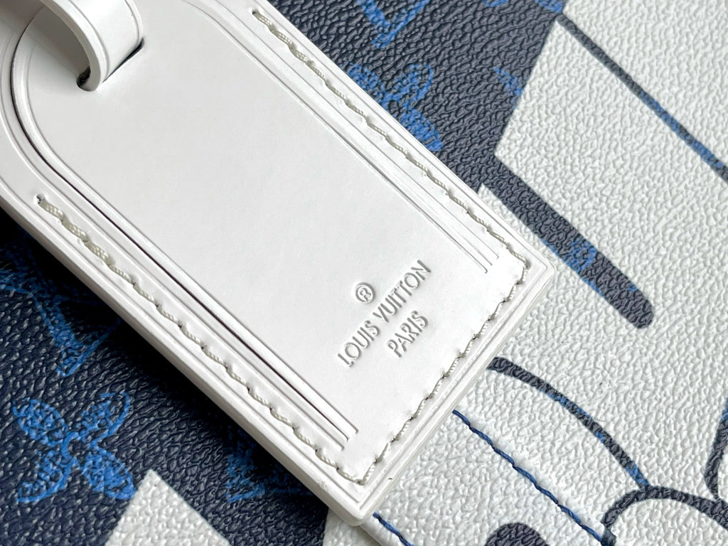White leather strap and Louis Vuitton Paris stamp on blue monogram bag