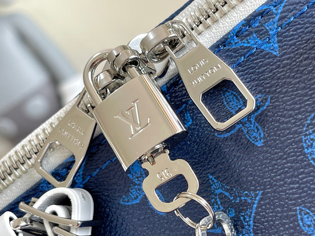 Blue monogram duffel bag with silver padlock charm and hardware