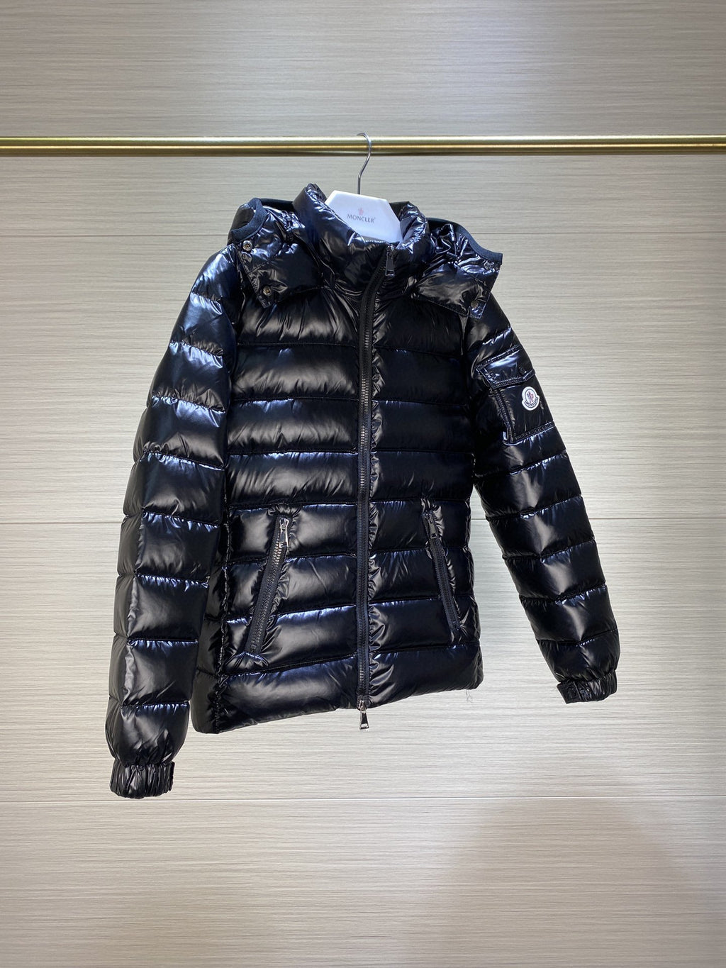 Dark puffer jacket with hood and full-zip front, quilted long sleeves