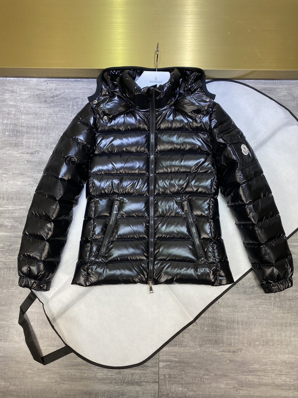 Dark puffer jacket with hood, full-zip front, quilted body and cuffed sleeves