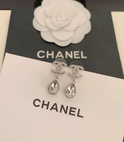Silver-tone stud and drop earrings with teardrop crystal stones