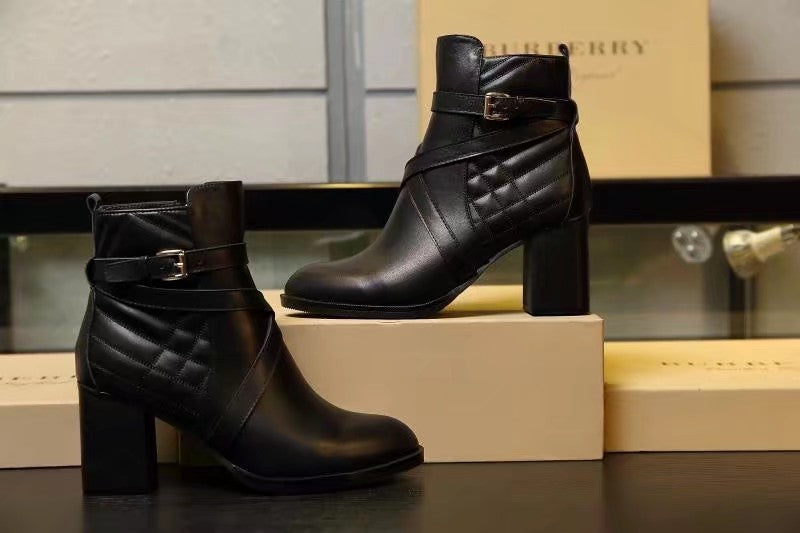 Black leather ankle boots with side buckle and quilted front panel