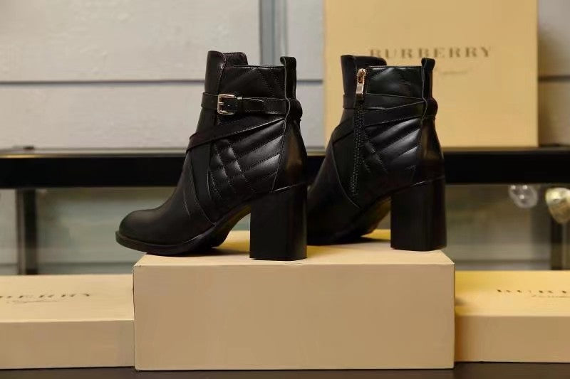 Black leather ankle boots with quilted detail and gold buckle