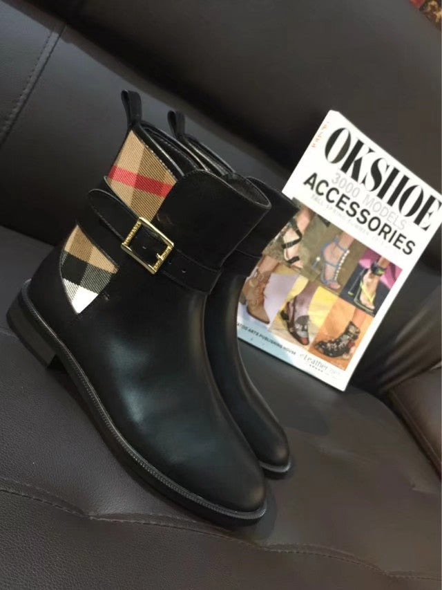 Black leather ankle boots with gold-tone buckle strap and plaid panel detail