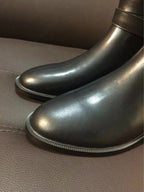 Black leather boot toe and rounded vamp with textured sole trim