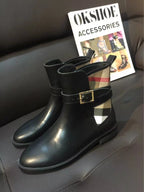 Black leather ankle boots with gold-tone buckle and plaid fabric side panel