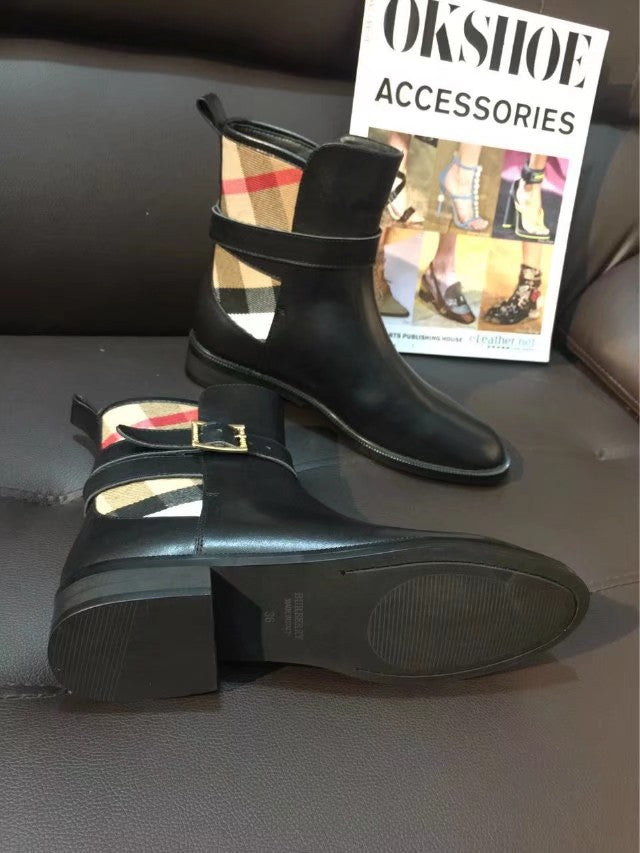 Black leather ankle boots with gold-tone buckle strap and plaid lining detail