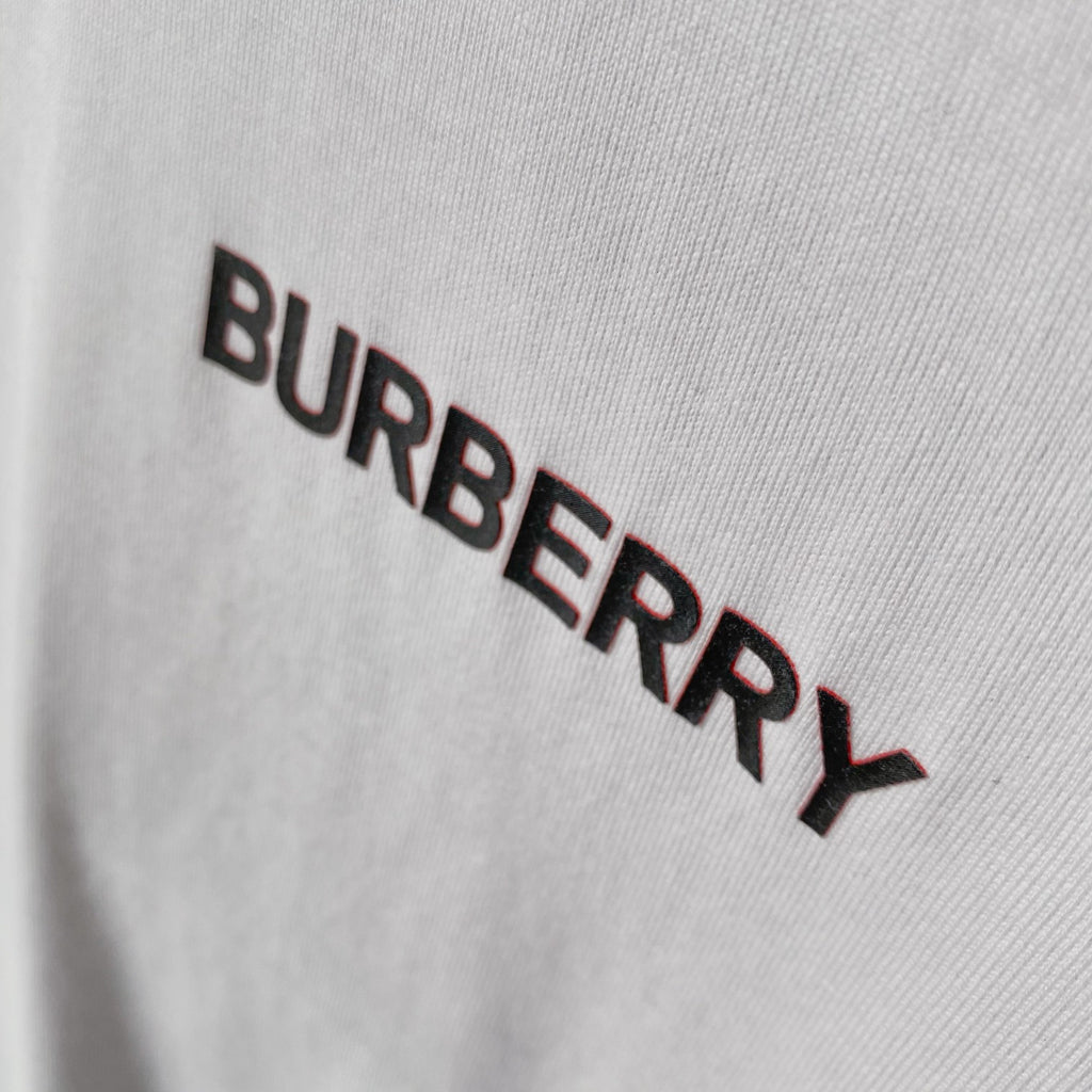 Burberry logo print on white fabric, close-up