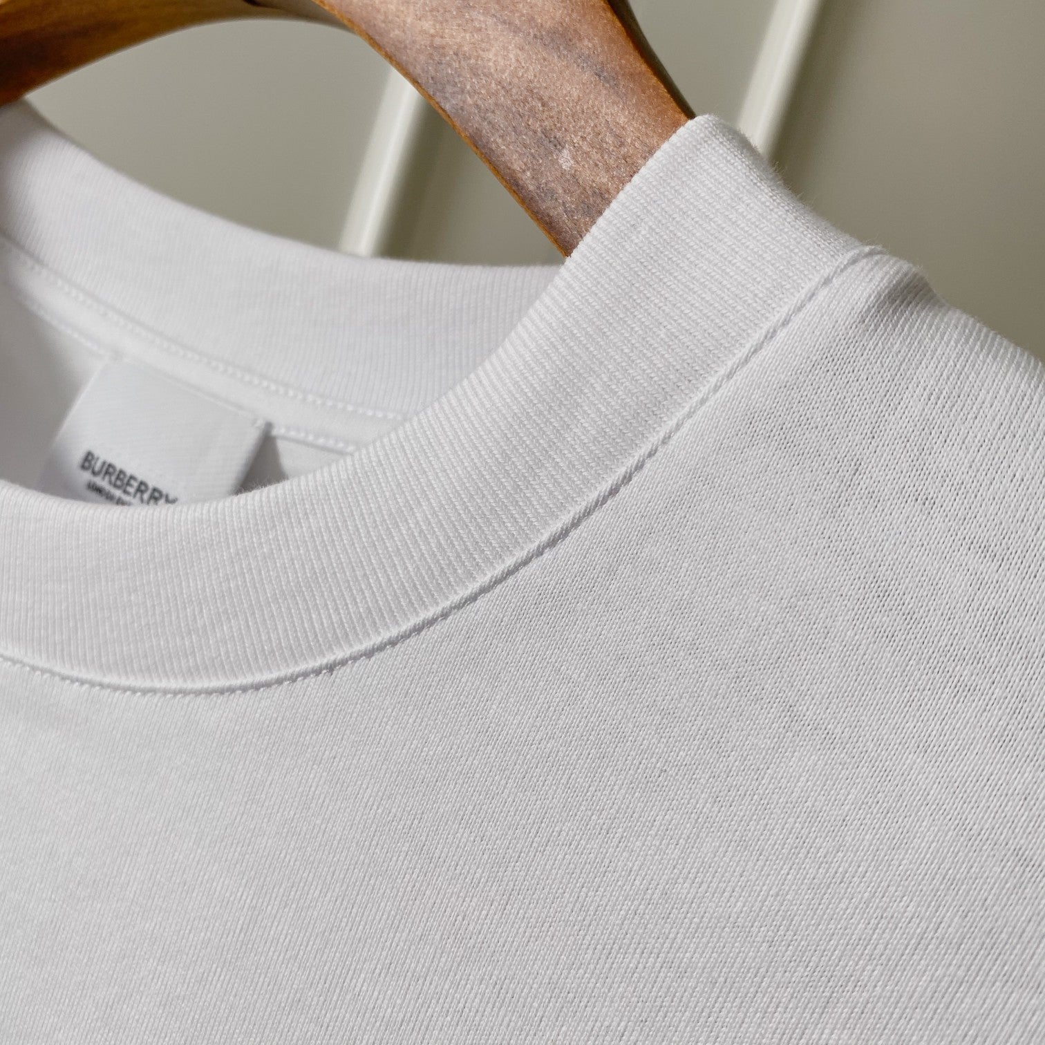 White Burberry T-shirt neckline and ribbed collar detail, close-up