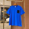 Men's blue short-sleeve T-shirt with black B logo patch at chest.