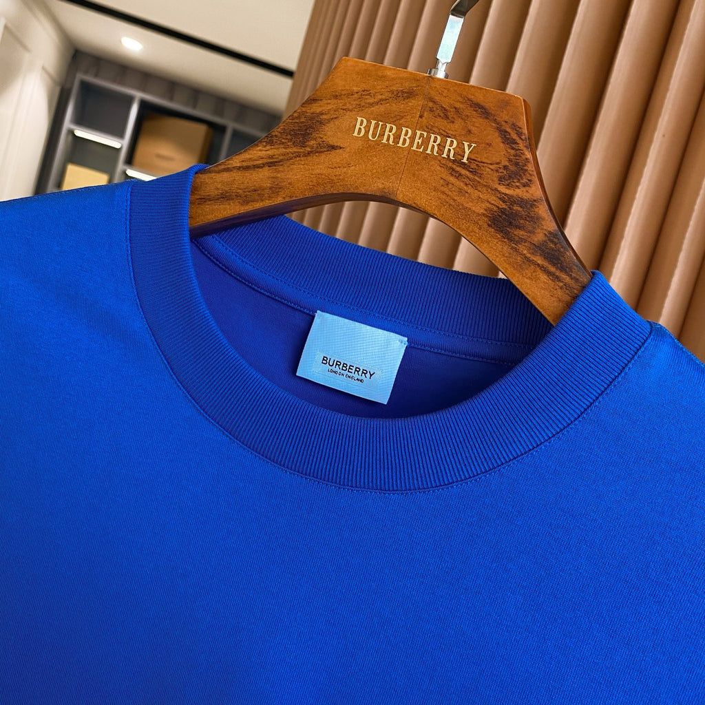 Blue crew-neck T-shirt with Burberry neckline tag and ribbed collar.