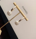 Gold-tone hoop earrings with dangling pearl beads and round crystal charms