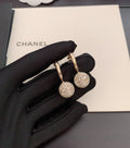 Gold-tone hoop earrings with round crystal charm and small pearl drop
