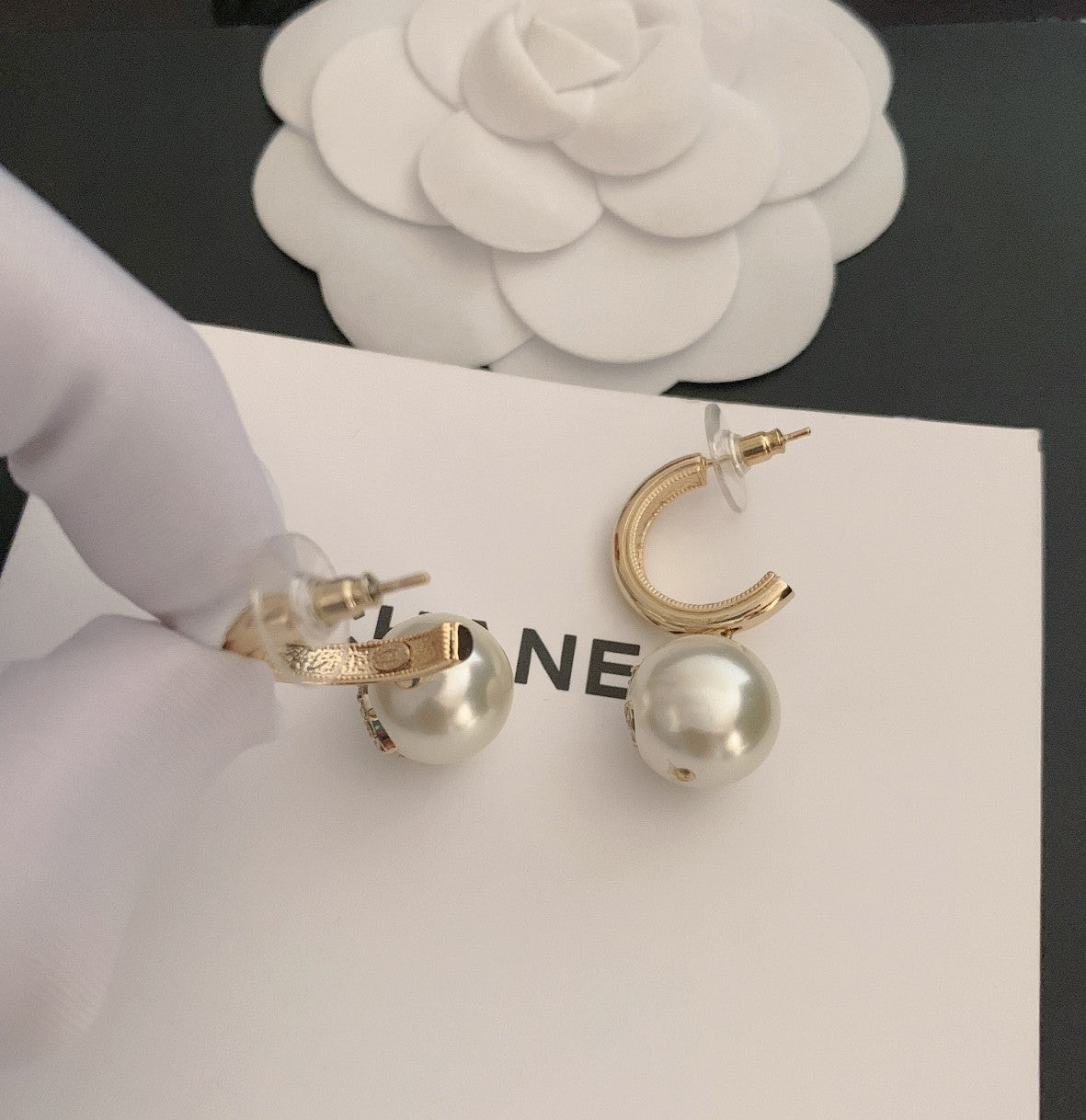 Gold-tone hoop earrings with pearl beads and round crystal charms