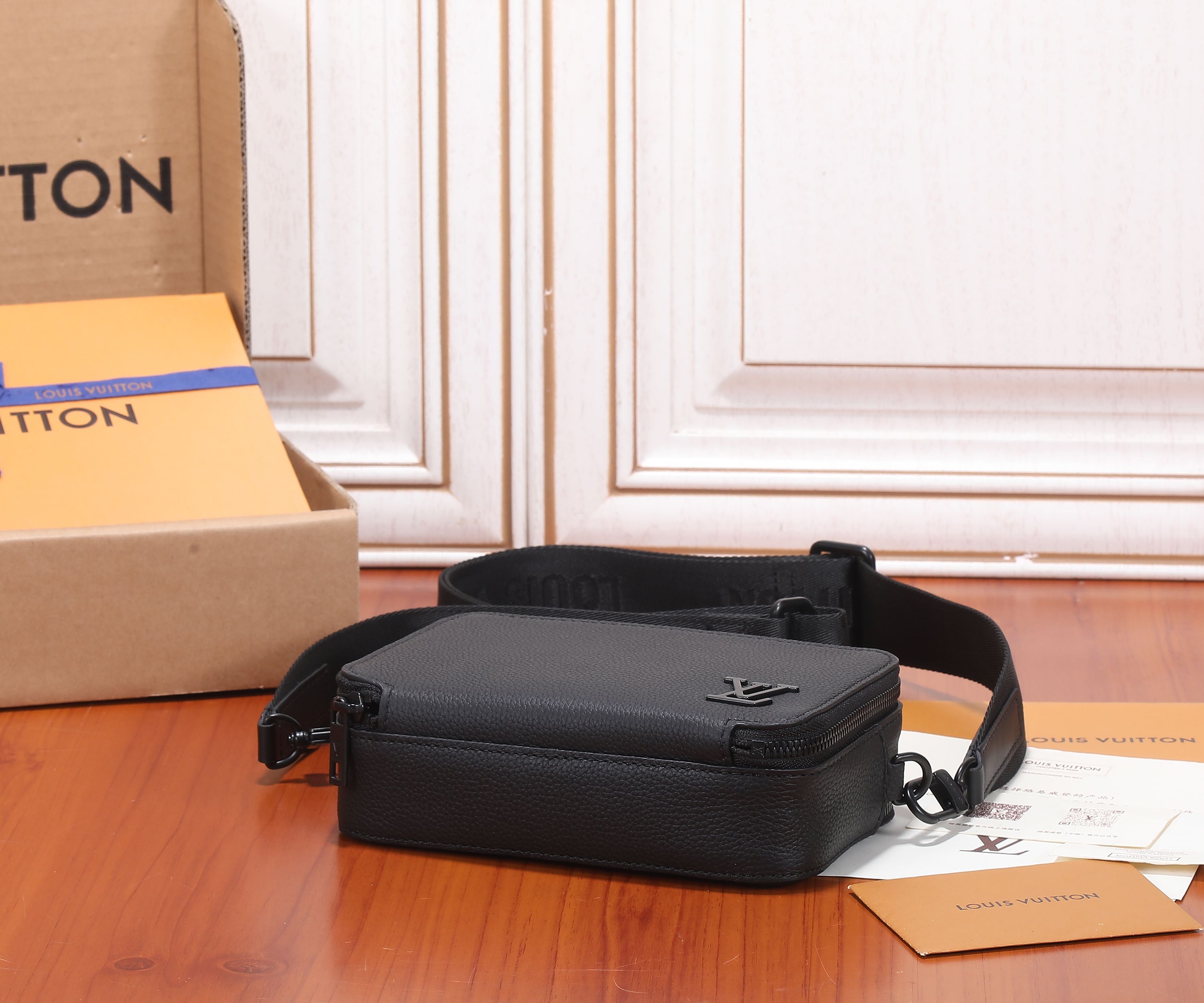Louis Vuitton men's crossbody bag, black leather with front logo and crossbody strap