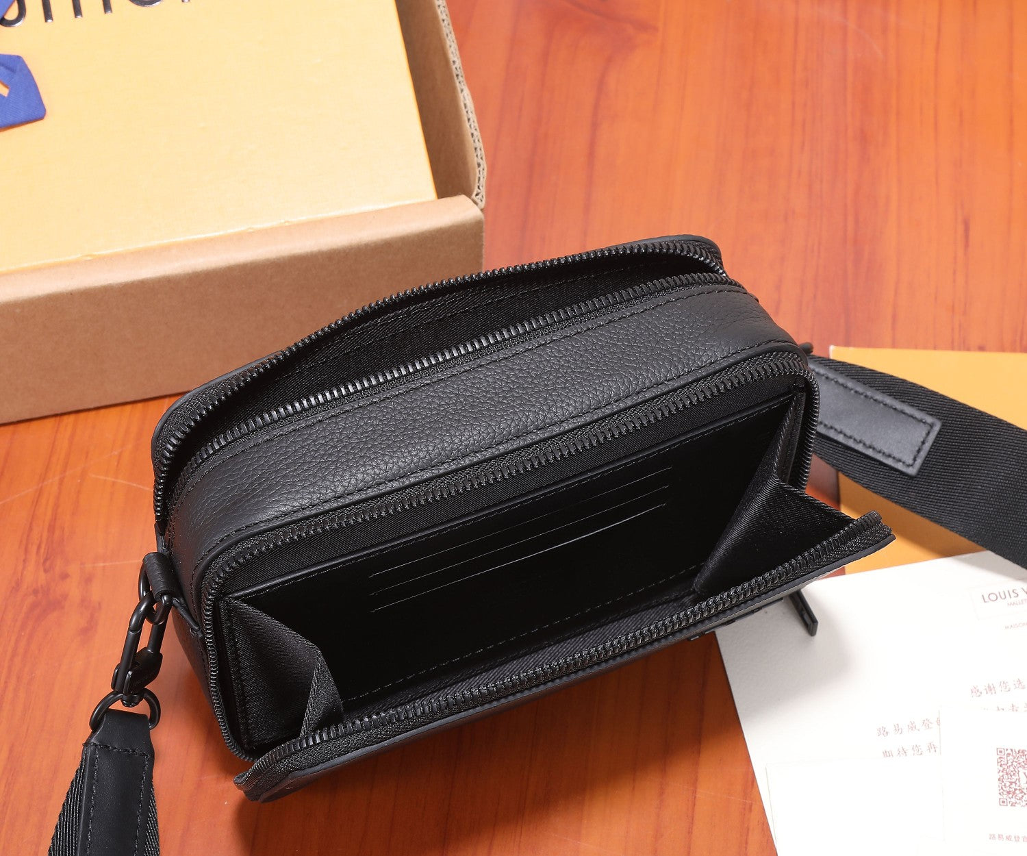 Louis Vuitton men's crossbody bag interior, open zip with black fabric lining