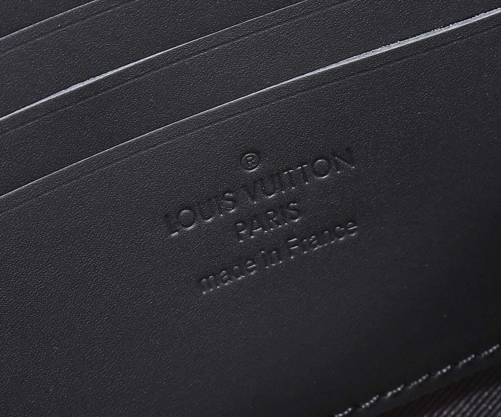 Black leather crossbody bag with debossed logo and branding on base panel