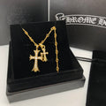 Gold cross pendant necklace with chain on black jewelry box