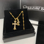 Gold cross pendant necklace with chain on black jewelry box