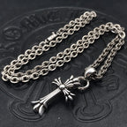 Silver-tone cross pendant necklace with decorative centerpiece and curb chain links