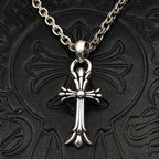 Silver-tone cross pendant necklace with curb chain and round center charm