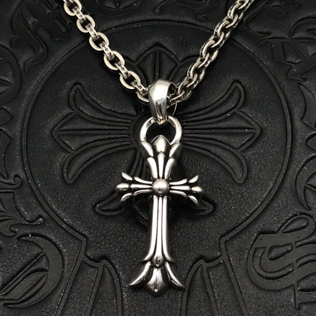 Silver-tone cross pendant necklace with curb chain and round center charm