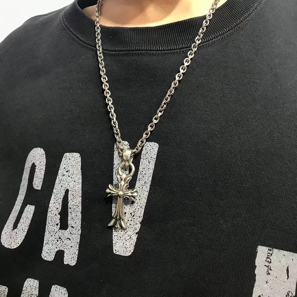 Silver-tone charm necklace with cross and letter pendant on chain