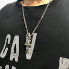 Silver-tone charm necklace with cross and letter pendant on chain