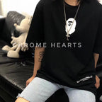 Silver-tone cross pendant necklace worn with black graphic T-shirt
